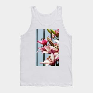 Fresh pink lilies at the fence background Tank Top